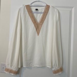 Cream colored long sleeve blouse